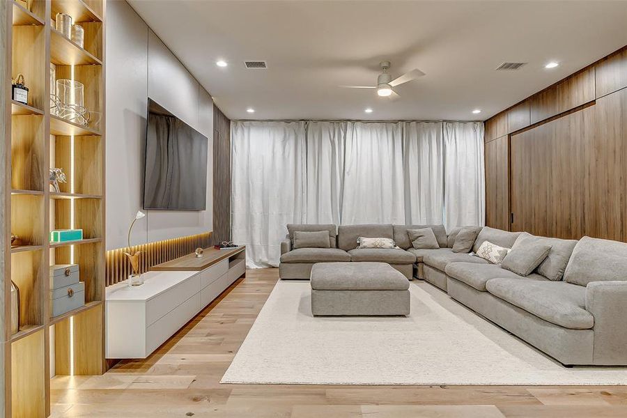 The ceiling-to-floor white blackout curtains transform this area into the perfect entertainment-watching experience.