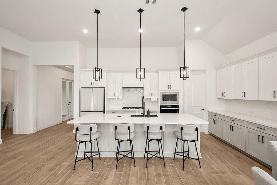Huge island in this bright kitchen is perfect for entertaining. Huge island in this bright kitchen is perfect for entertaining.