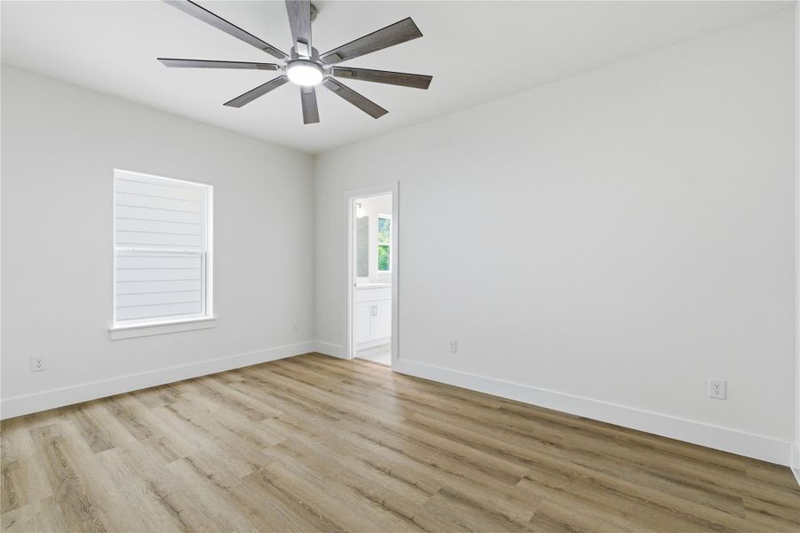 A well-sized secondary bedroom offers clean finishes, natural light, and direct access to a en-suite bath.