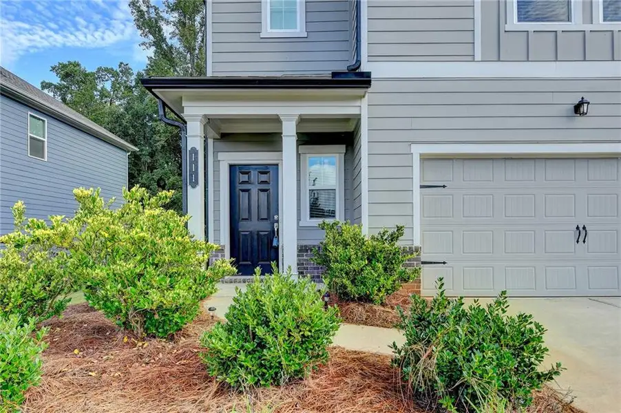 Front exterior of a new home in , Braselton, GA, highlighting curb appeal (Image 1).