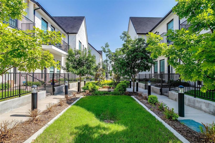 View of home's community with a fenced front yard, a residential view, and a yard