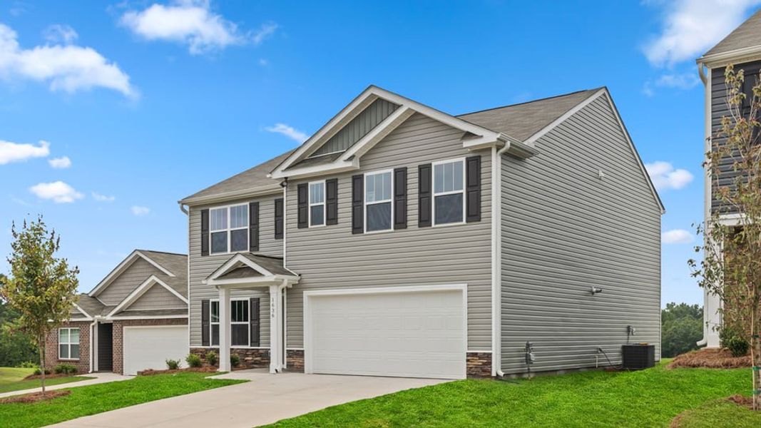 Front exterior of a new home in Ravencrest, Roebuck, SC, highlighting curb appeal (Image 2). Front exterior of a new home in Ravencrest, Roebuck, SC, highlighting curb appeal (Image 2).