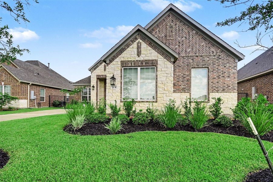 This charming brick and stone home features a well-maintained front yard with lush landscaping. The elegant exterior is complemented by large windows and a welcoming entrance, perfect for comfortable living. This charming brick and stone home features a well-maintained front yard with lush landscaping. The elegant exterior is complemented by large windows and a welcoming entrance, perfect for comfortable living.