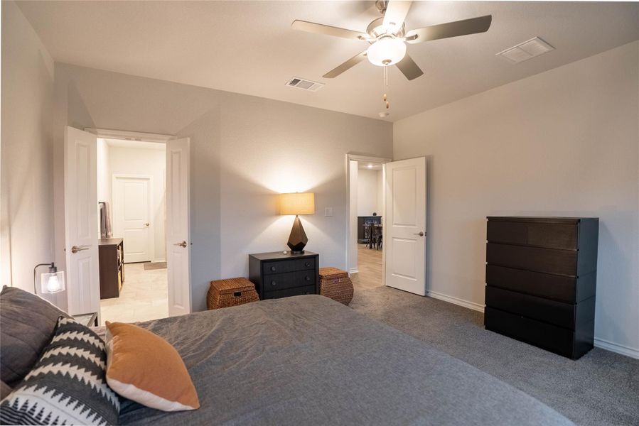 Bedroom featuring ceiling fan and light colored carpet Bedroom featuring ceiling fan and light colored carpet