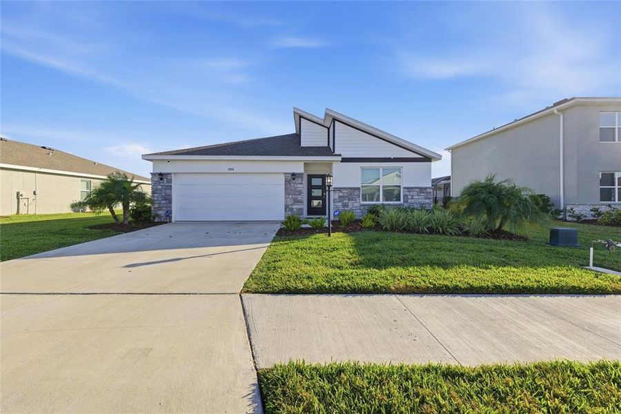 Front exterior of a new home in , Bradenton, FL, highlighting curb appeal (Image 24).