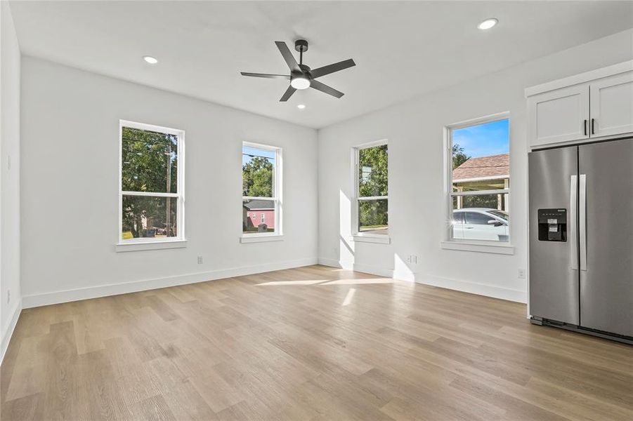 Unfurnished dining area featuring plenty of natural light, light wood-type flooring, recessed lighting, and a ceiling fan