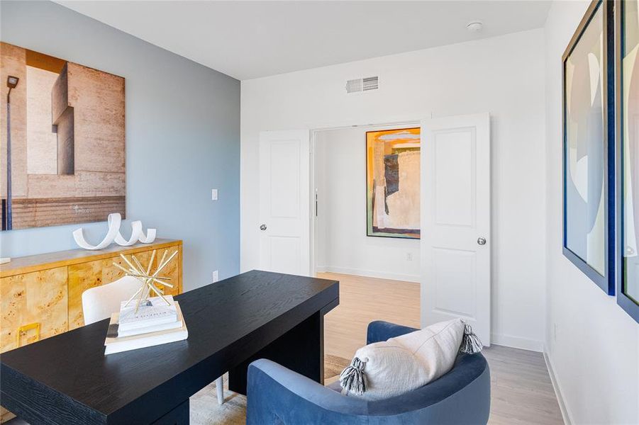 Office area with hardwood / wood-style flooring