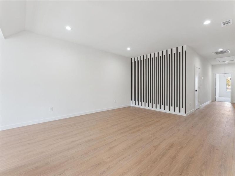 Unfurnished room with light wood-style floors, attic access, visible vents, and recessed lighting