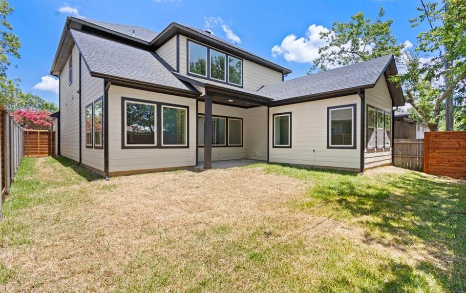 Back of house featuring a lawn