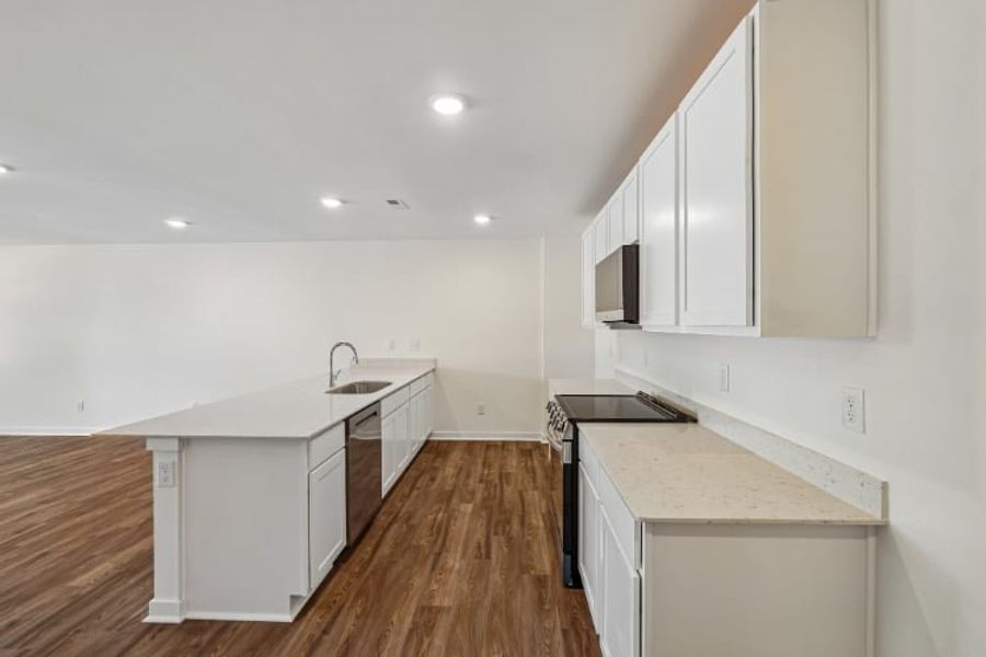 A kitchen with white cabinets.
