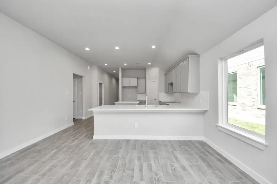 All of this overlooks your expansive family room, creating a perfect space for culinary delights and family gatherings. Sample photo of completed home with similar floor plan. Actual colors and selections may vary. All of this overlooks your expansive family room, creating a perfect space for culinary delights and family gatherings. Sample photo of completed home with similar floor plan. Actual colors and selections may vary.