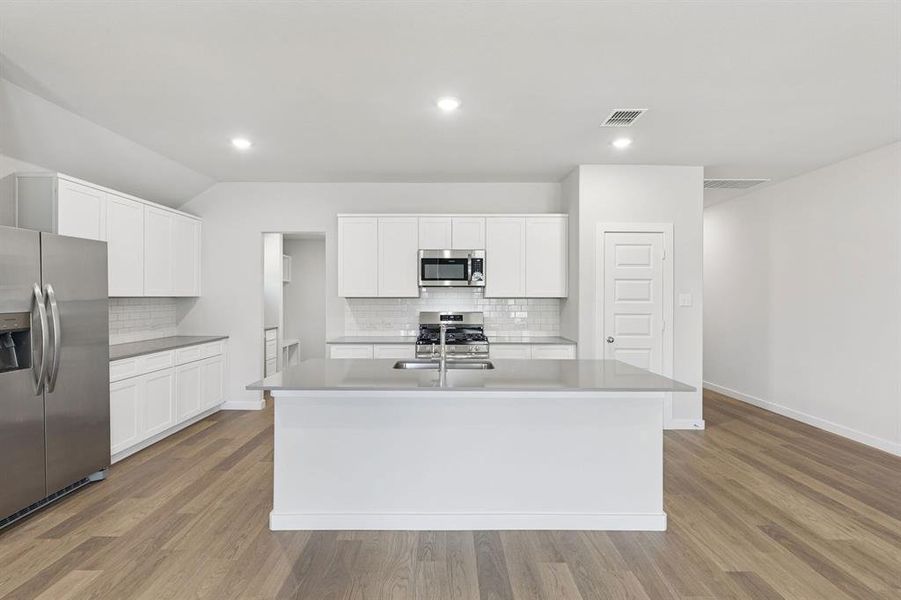 Kitchen in the Harrison home plan by Trophy Signature Homes – REPRESENTATIVE PHOTO