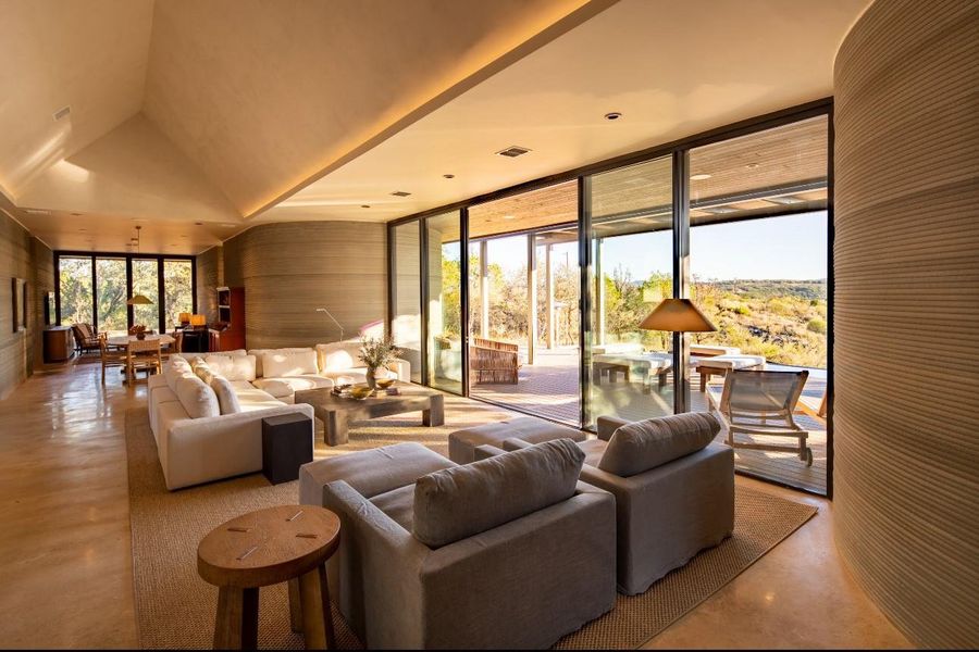 Living room featuring expansive windows and vaulted ceiling