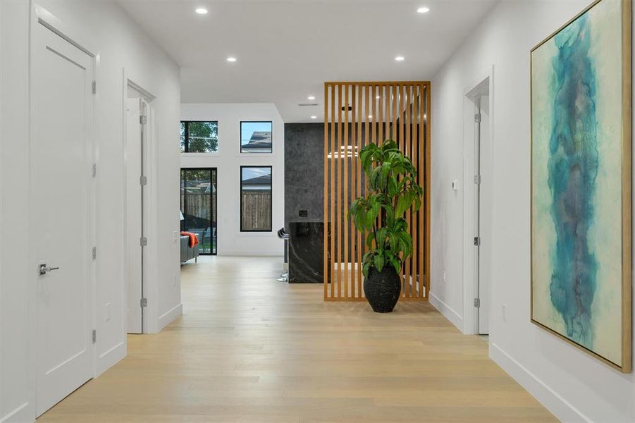 Hallway with light wood-style floors and recessed lighting Hallway with light wood-style floors and recessed lighting