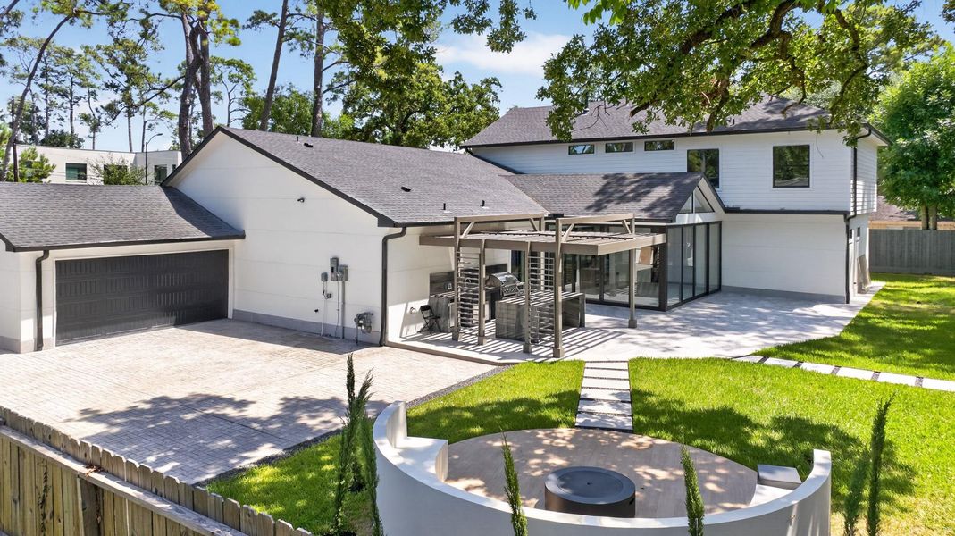 Rear elevation showcases the home’s scale, outdoor entertaining areas and beautifully maintained grounds.
