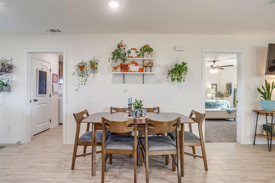 Dining area with light wood-style flooring and recessed lighting Dining area with light wood-style flooring and recessed lighting