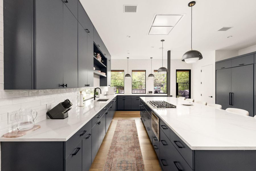 Clean lines and modern finishes define this kitchen, featuring sleek cabinetry and a spacious island. Clean lines and modern finishes define this kitchen, featuring sleek cabinetry and a spacious island.