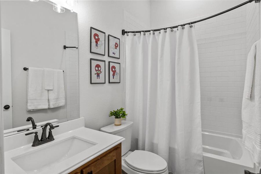 Bathroom with shower / bath combo and vanity