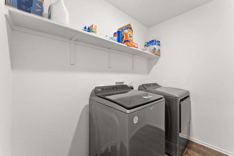 Laundry room with washing machine and dryer, laundry area, and baseboards