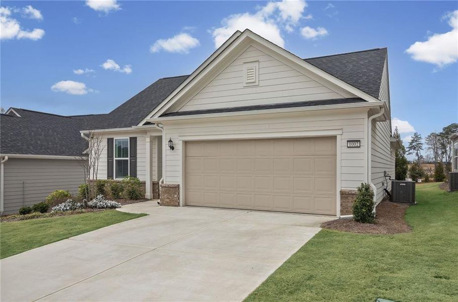 Front exterior of a new home in Sun City Peachtree, Griffin, GA, highlighting curb appeal (Image 23).