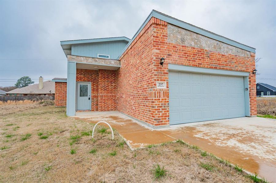 Front exterior of a new home in , Gun Barrel City, TX, highlighting curb appeal (Image 2). Front exterior of a new home in , Gun Barrel City, TX, highlighting curb appeal (Image 2).