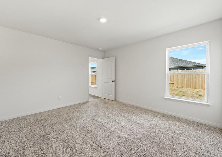 The master bedroom of the Rio Grande floor plan has a large window.