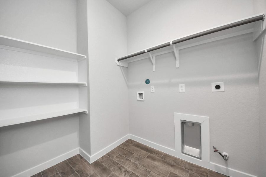 A perfect blend of functionality and comfort. Capture the essence of easy living with a first-floor laundry room, thoughtfully equipped with shelving for effortless organization. Both electric and gas connections available. A perfect blend of functionality and comfort. Capture the essence of easy living with a first-floor laundry room, thoughtfully equipped with shelving for effortless organization. Both electric and gas connections available.