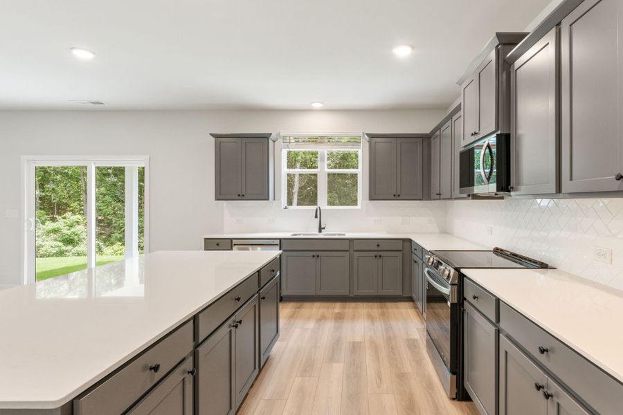 A kitchen with black cabinets.