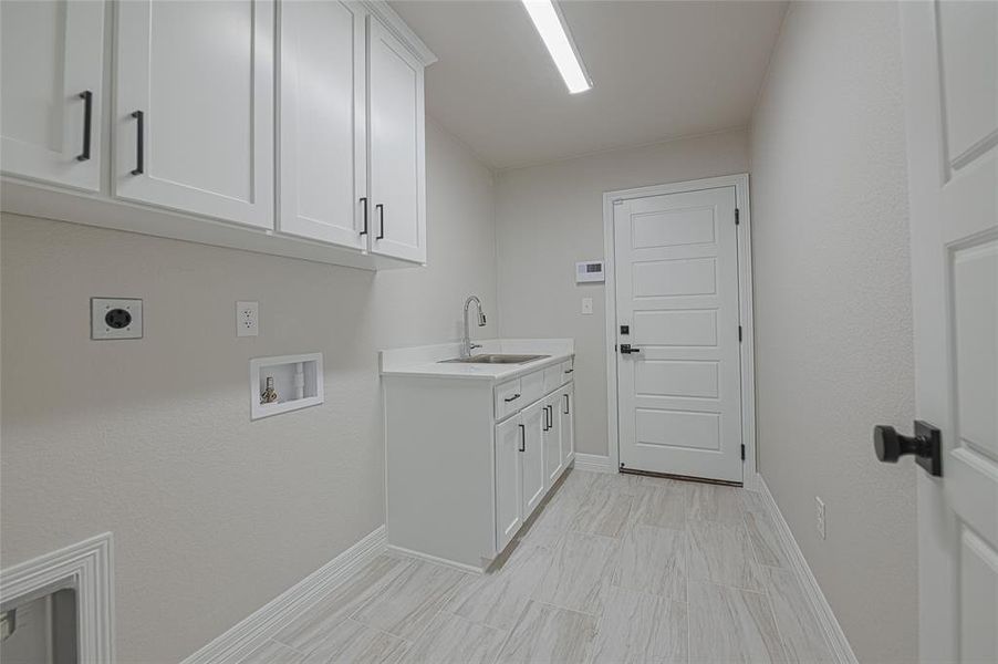 Washroom with cabinet space, hookup for an electric dryer, and washer hookup