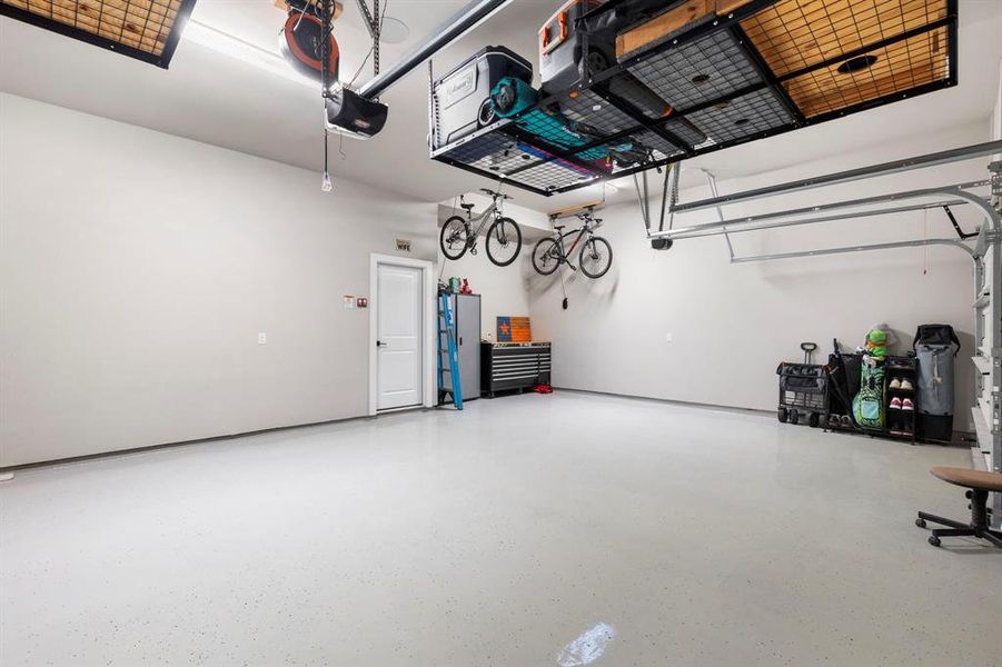 This three car garage has epoxy flooring and has plenty of room for vehicles and work space!