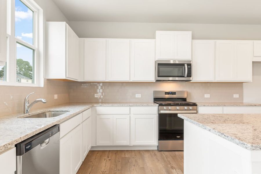 A kitchen with white cabinets. A kitchen with white cabinets.