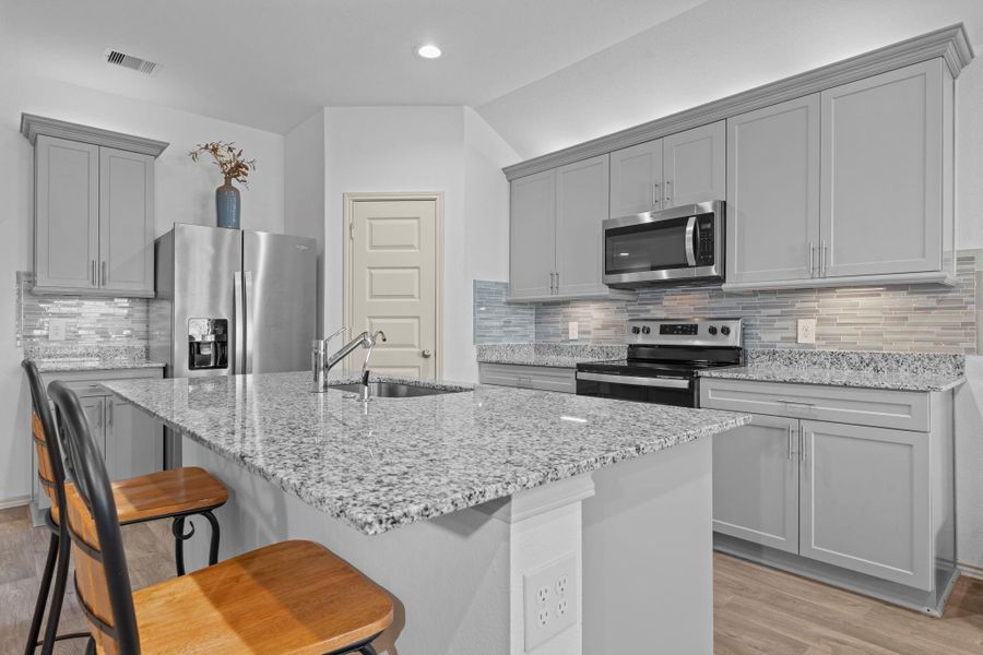 Crisp, modern kitchen design with ample cabinetry, shimmering granite counters, deep stainless steel undermount sink, pull out kitchen faucet and plenty of prep space — ready for all your cooking adventures and entertaining needs. Crisp, modern kitchen design with ample cabinetry, shimmering granite counters, deep stainless steel undermount sink, pull out kitchen faucet and plenty of prep space — ready for all your cooking adventures and entertaining needs.