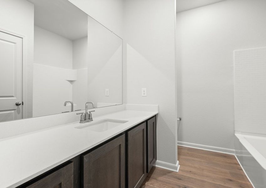 The seconadry bathroom has a large vanity and a shower-tub combo. The seconadry bathroom has a large vanity and a shower-tub combo.