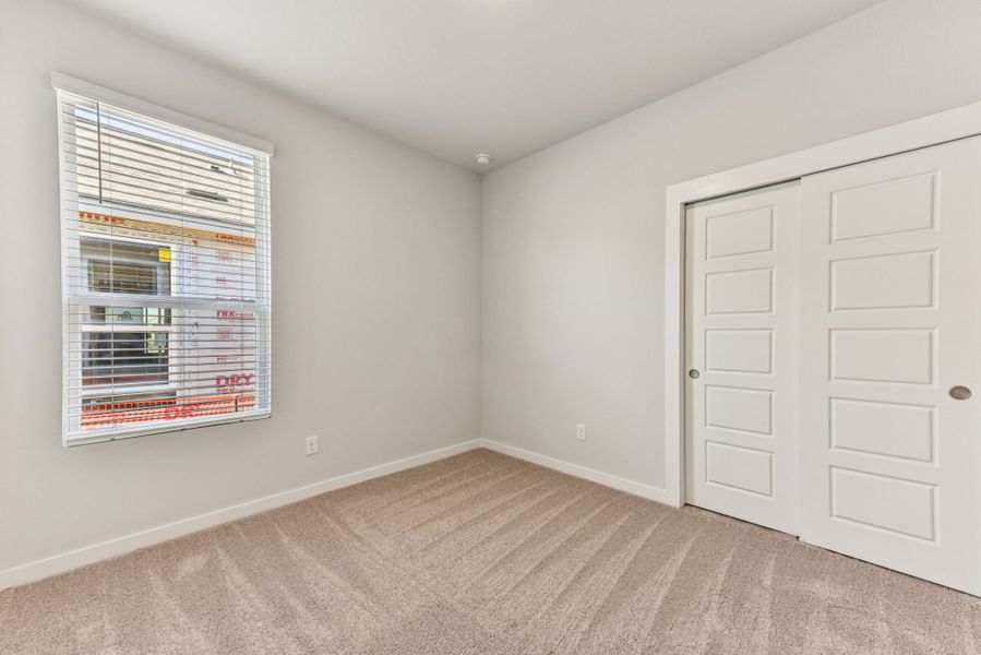 A room with a window and a door.