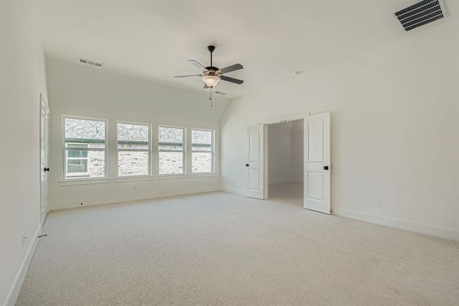 Unfurnished room featuring light carpet and ceiling fan Unfurnished room featuring light carpet and ceiling fan