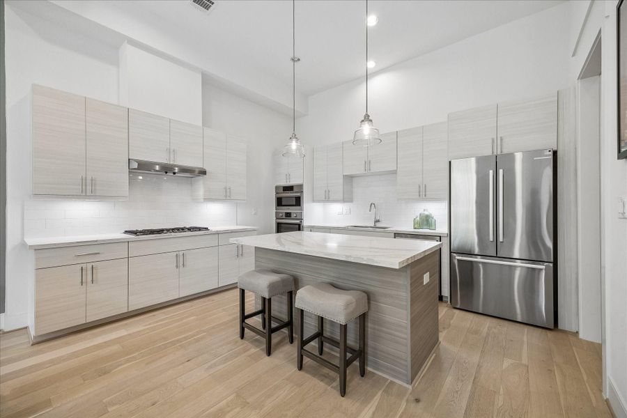 Island kitchen with quartz countertops and Bosch appliances. Refrigerator included is a *bonus*! Island kitchen with quartz countertops and Bosch appliances. Refrigerator included is a *bonus*!