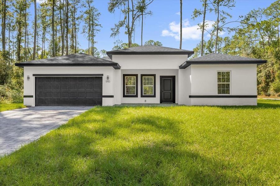 Front exterior of a new home in , Citrus Springs, FL, highlighting curb appeal (Image 1).