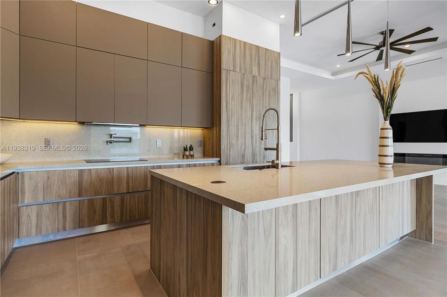 Quartz countertops, full backsplash, farmhouse sink, and chrome fixtures.