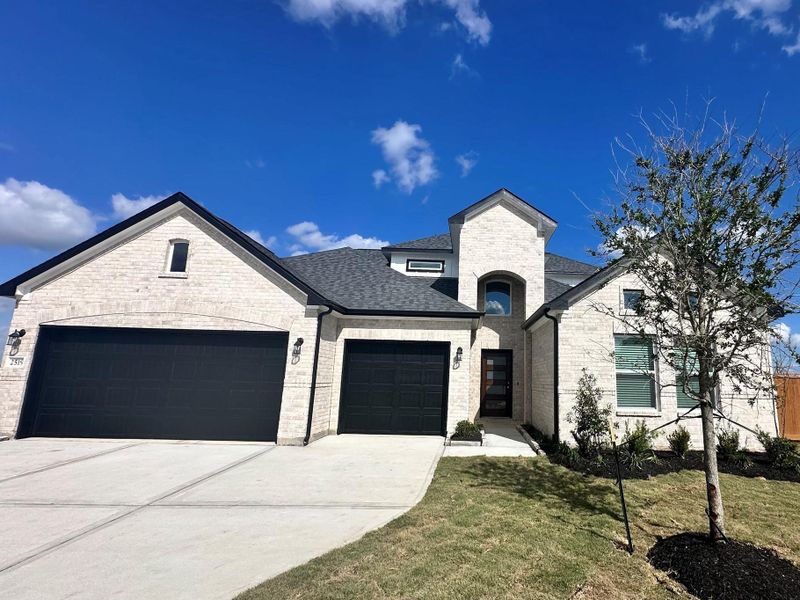 Front exterior of a new home in Rates starting as low as, Iowa Colony, TX, highlighting curb appeal (Image 1). Front exterior of a new home in Rates starting as low as, Iowa Colony, TX, highlighting curb appeal (Image 1).