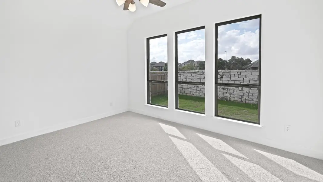 Unfurnished room with light colored carpet, ceiling fan, and lofted ceiling