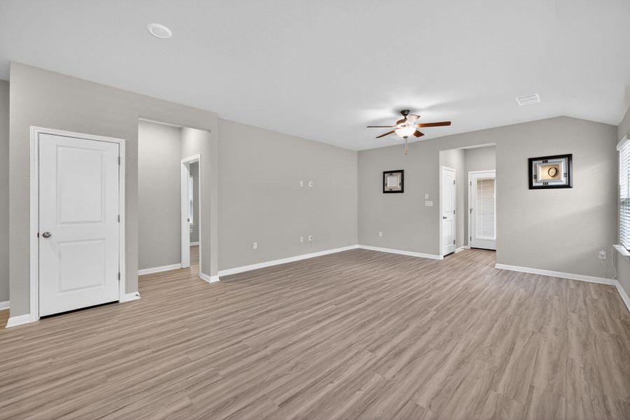 Unfurnished living room with ceiling fan and light wood-type flooring