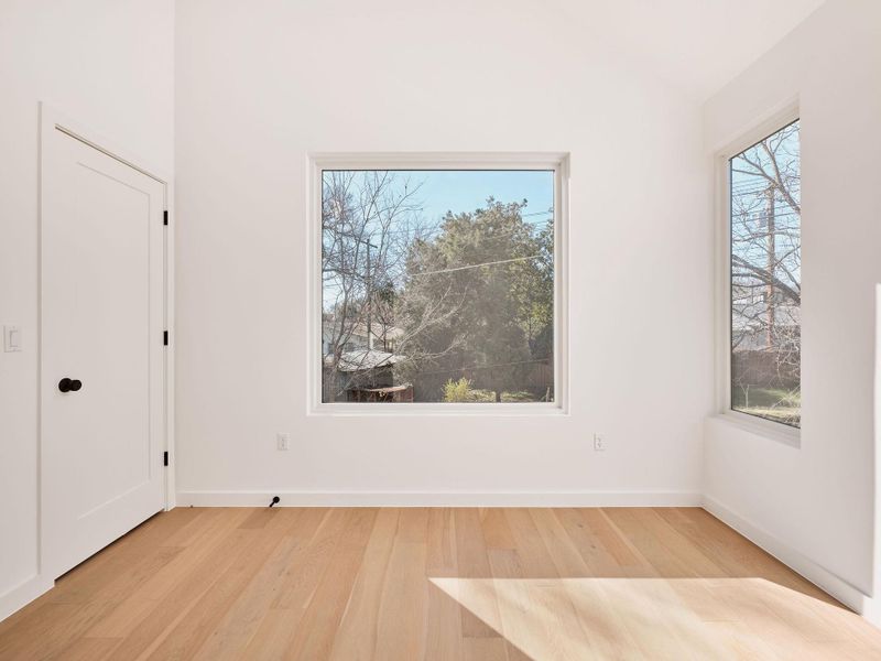 Spare room featuring light wood-style flooring and plenty of natural light