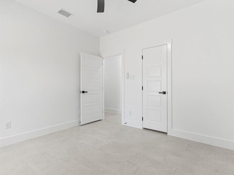Unfurnished bedroom featuring baseboards and a ceiling fan