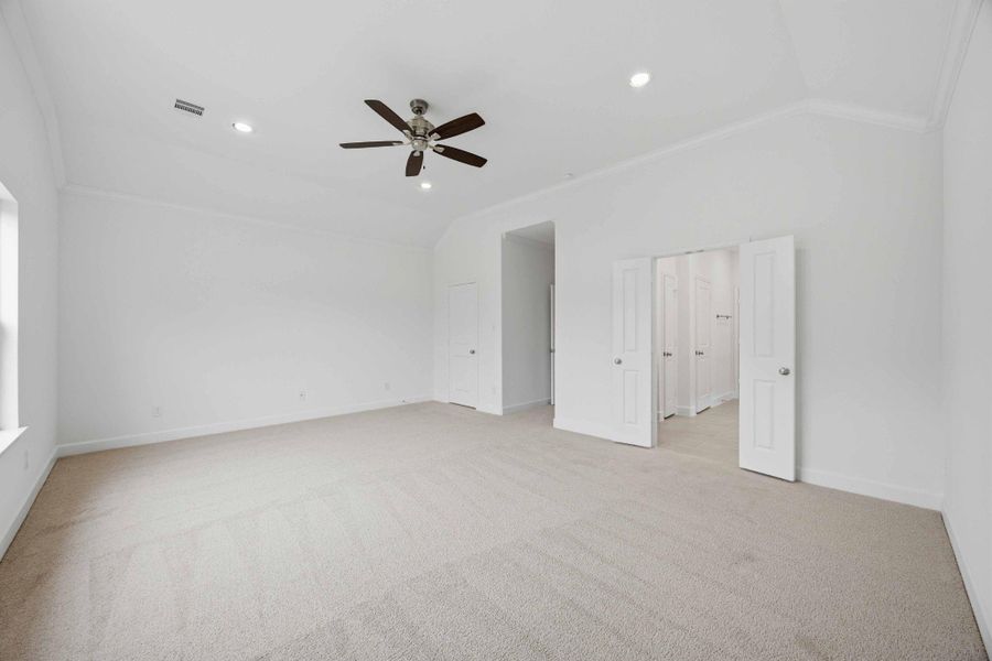 Retreat in Style. With two spacious walk-in closets—one in the bedroom, one in the bath—this vaulted primary suite was designed with real life in mind.