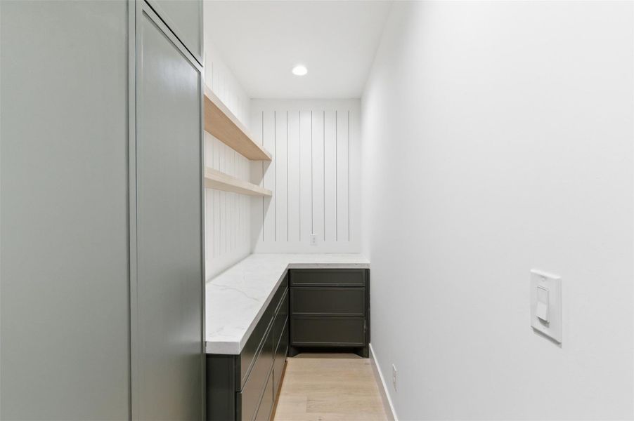 Designed for effortless entertaining, this beautifully appointed butler’s pantry offers additional storage, prep space, and a seamless extension of the main kitchen.