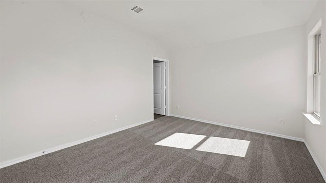 Unfurnished room with carpet floors and vaulted ceiling