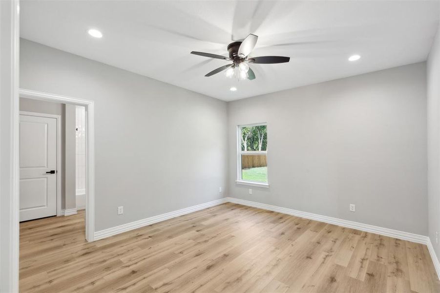 Spare room featuring ceiling fan and light hardwood / wood-style floors