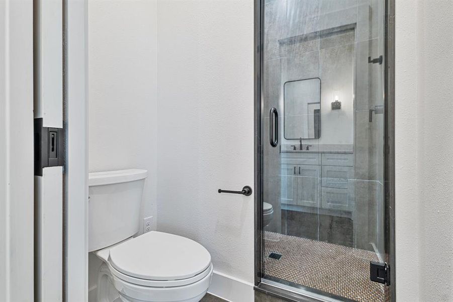 Bathroom with a shower with door and toilet