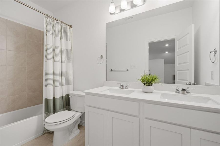 Spacious secondary upstairs bathroom with dual sinks, large mirror, and clean neutral design. Functional, fresh, and ideal for busy mornings.