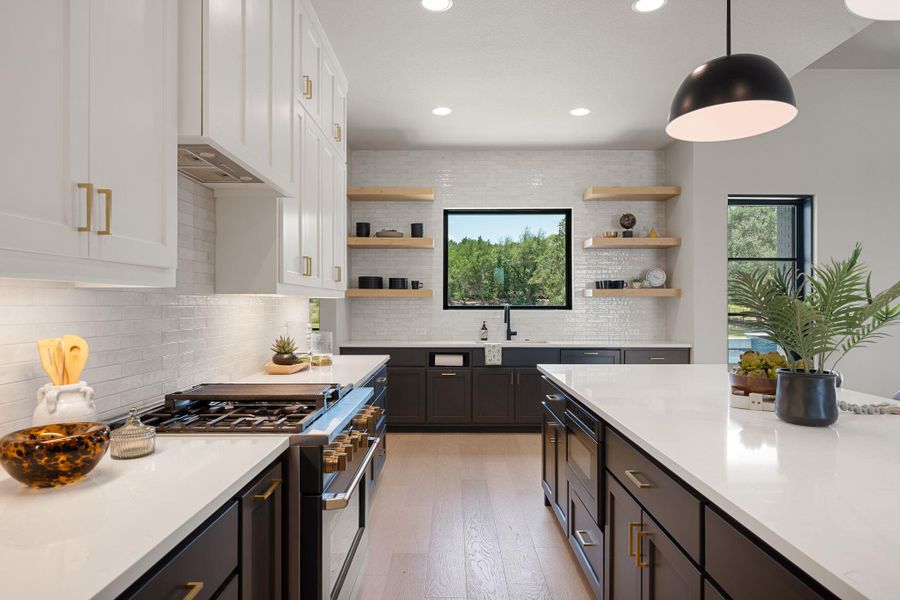 Clean lines and warm wood accents define this modern kitchen anchored by a spacious island.